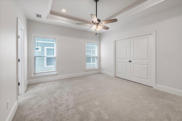 1544 Miccosukee Loop, Tallahassee, FL 32308 - unfurnished bedroom with carpet floors, baseboards, a closet, a tray ceiling, and crown molding