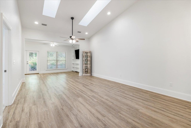 1544 Miccosukee Loop, Tallahassee, FL 32308 - unfurnished living room with a skylight, vaulted ceiling, light wood-style floors, ceiling fan, and baseboards