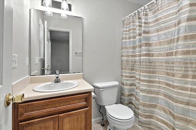 full bath with tile patterned floors, vanity, toilet, and curtained shower