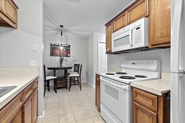 kitchen featuring white appliances, light tile patterned floors, light countertops, brown cabinets, and baseboards