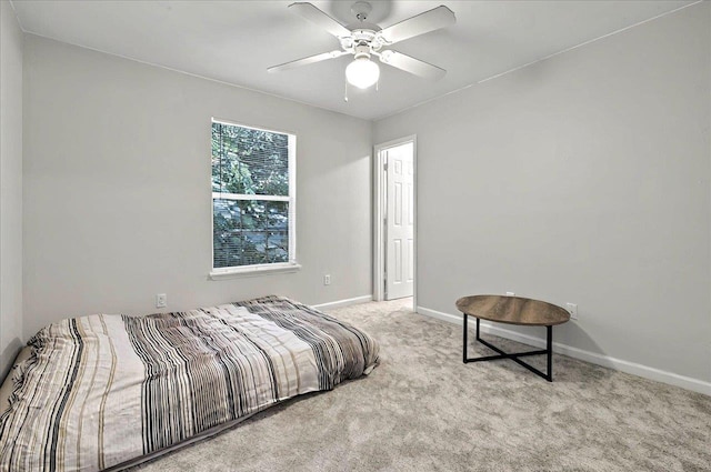 bedroom featuring baseboards, ceiling fan, and carpet flooring