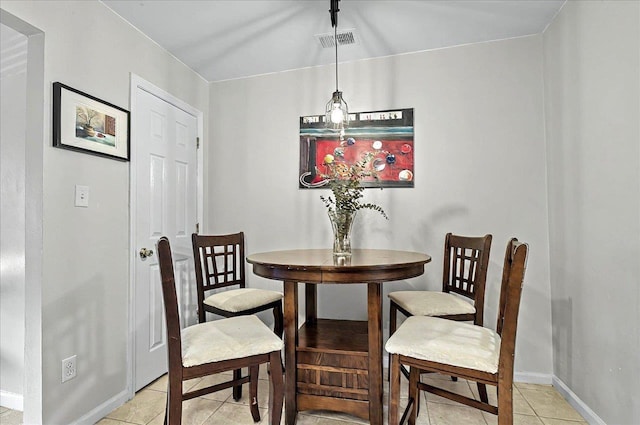 dining room with light tile patterned floors, visible vents, and baseboards