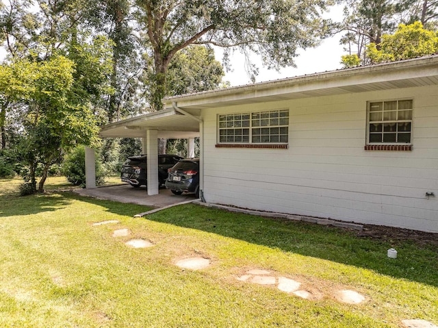 view of property exterior with a carport and a yard