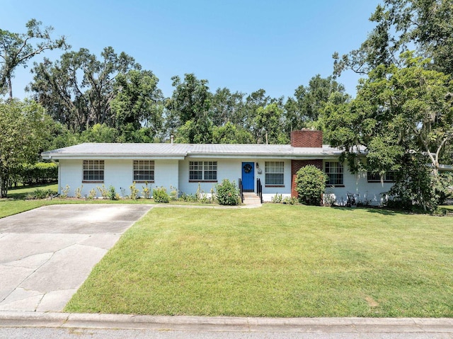 ranch-style home featuring a front yard