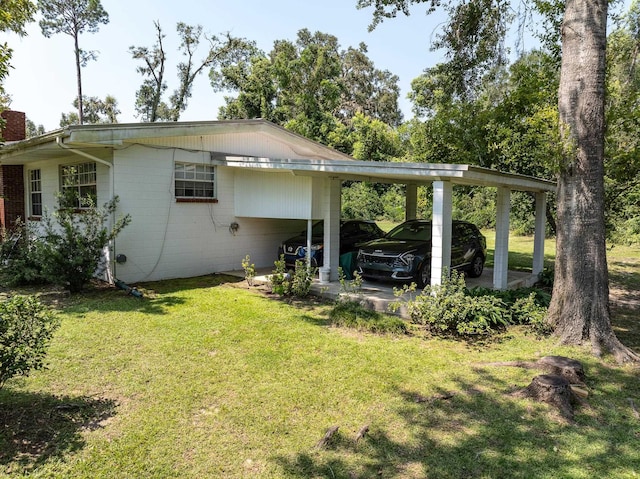 back of property with a yard and a carport