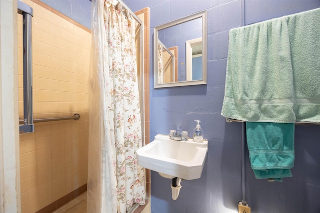 bathroom with walk in shower and sink