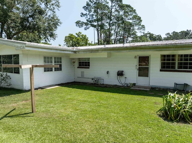 back of house with a lawn