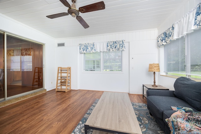 living room featuring crown molding and dark wood-type flooring