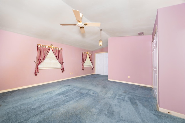 unfurnished room featuring vaulted ceiling, ceiling fan, and dark colored carpet