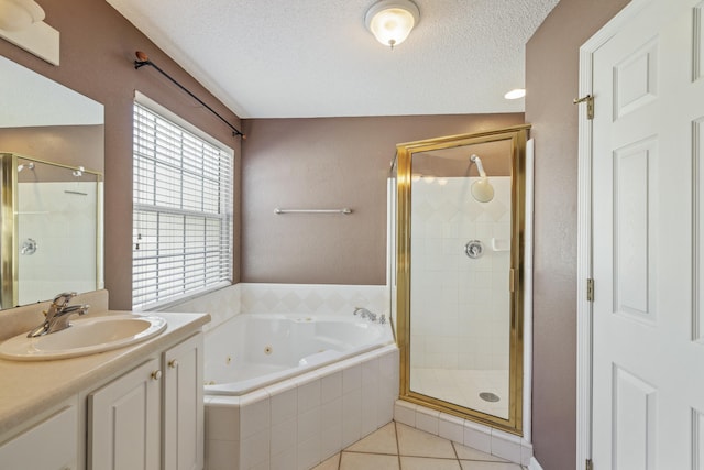 bathroom with a shower stall, a tub with jets, a textured ceiling, and tile patterned floors