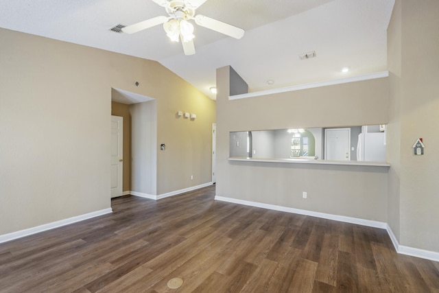 unfurnished room with lofted ceiling, baseboards, visible vents, and wood finished floors