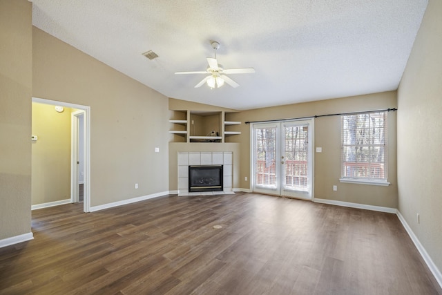 unfurnished living room featuring baseboards, dark wood-style floors, ceiling fan, vaulted ceiling, and a fireplace