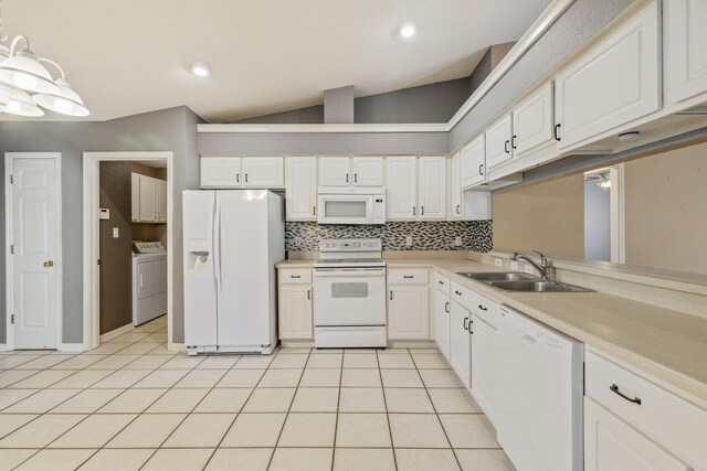 kitchen featuring light countertops, decorative backsplash, a sink, washer / dryer, and white appliances