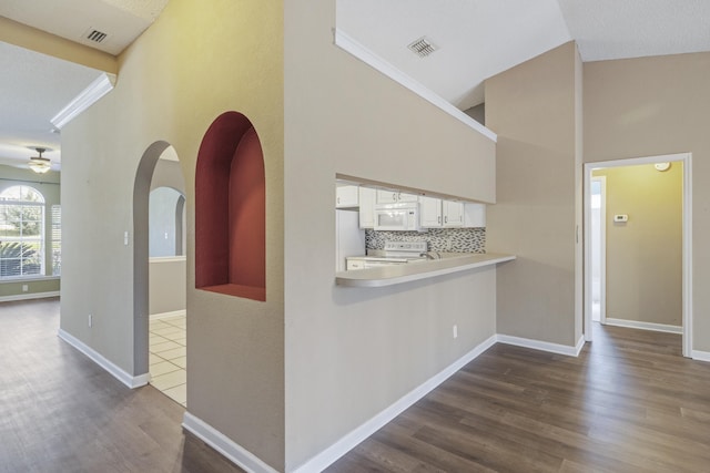 hall with dark wood-style floors, baseboards, and visible vents