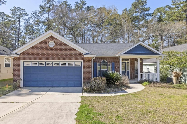 ranch-style home with covered porch, a garage, brick siding, driveway, and a front lawn