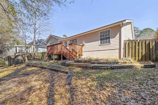 back of house featuring stairway, fence, and a wooden deck