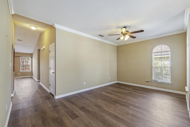 unfurnished room featuring ceiling fan, dark wood-style flooring, visible vents, baseboards, and ornamental molding