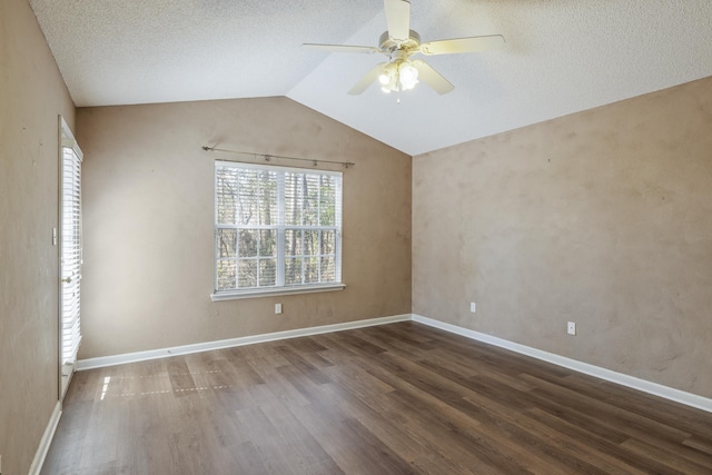 spare room featuring lofted ceiling, wood finished floors, a ceiling fan, and baseboards