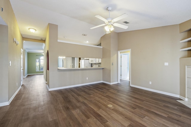 unfurnished living room featuring ceiling fan, dark wood-type flooring, lofted ceiling, and visible vents