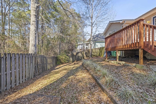 view of yard with a fenced backyard and a deck