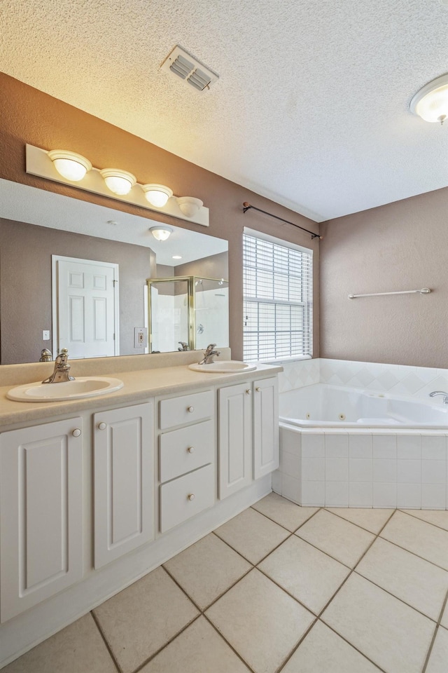 bathroom featuring a sink, a shower stall, a whirlpool tub, and tile patterned floors