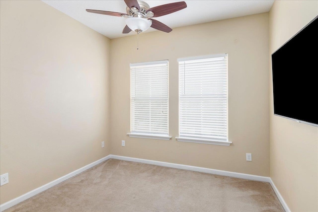 spare room featuring ceiling fan and light colored carpet