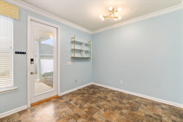 unfurnished room featuring plenty of natural light, a chandelier, a textured ceiling, and ornamental molding