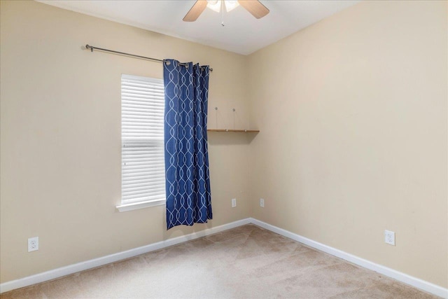 spare room featuring carpet and ceiling fan