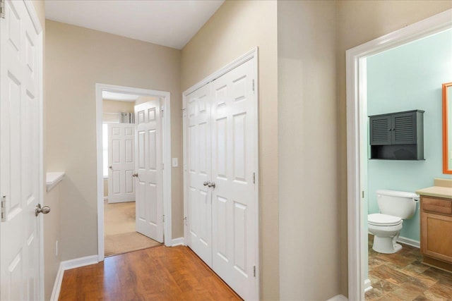 hallway with hardwood / wood-style floors