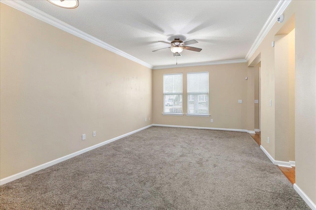 carpeted empty room featuring ceiling fan and crown molding