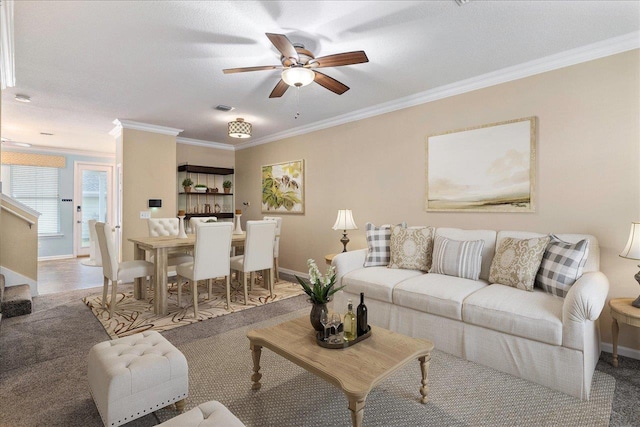 carpeted living room with a textured ceiling, ceiling fan, and ornamental molding