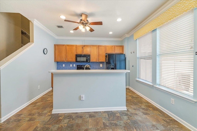 kitchen with black appliances, ornamental molding, a kitchen island with sink, and tasteful backsplash