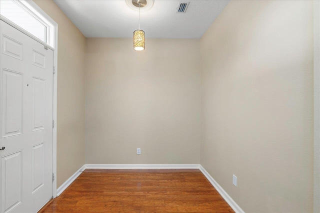 empty room with hardwood / wood-style flooring