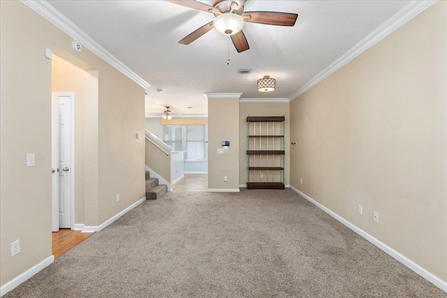 unfurnished living room featuring crown molding, ceiling fan, light colored carpet, and a textured ceiling