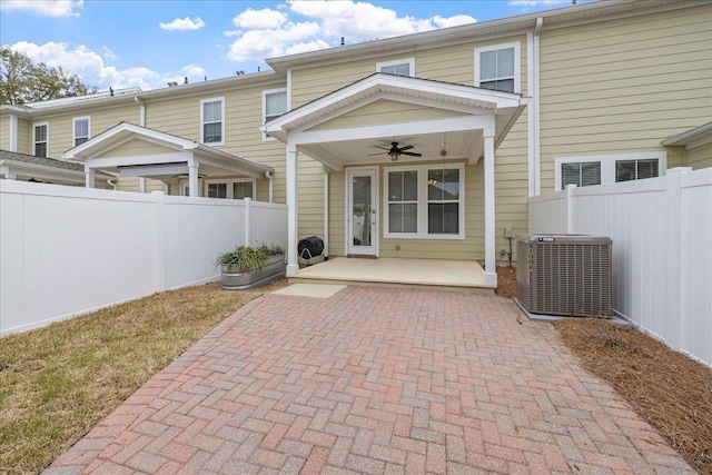 back of property featuring ceiling fan and cooling unit