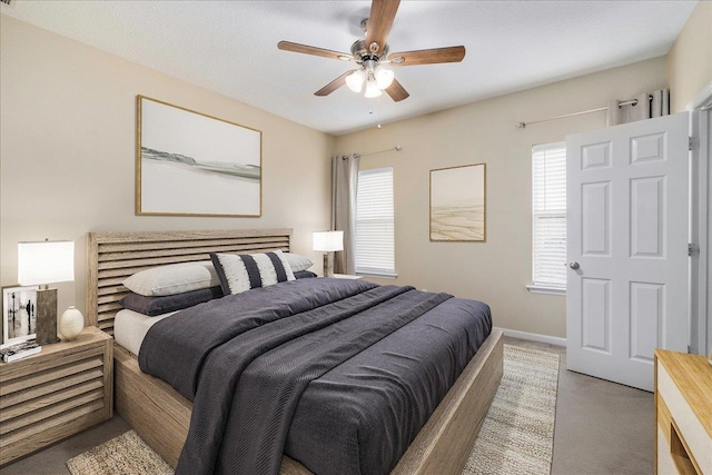 bedroom with carpet, multiple windows, and ceiling fan