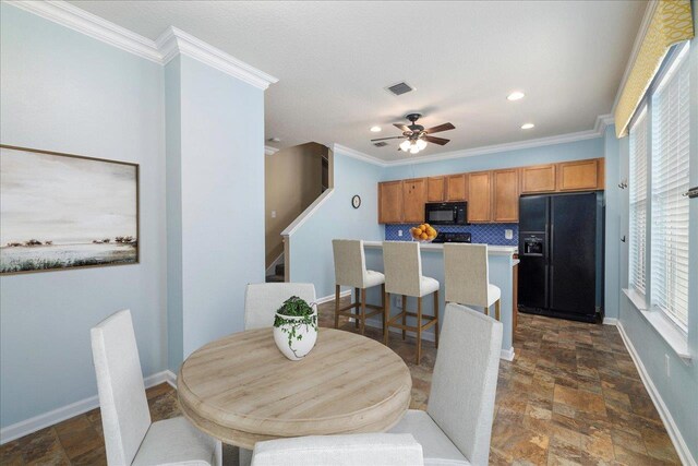 dining area featuring ceiling fan and ornamental molding