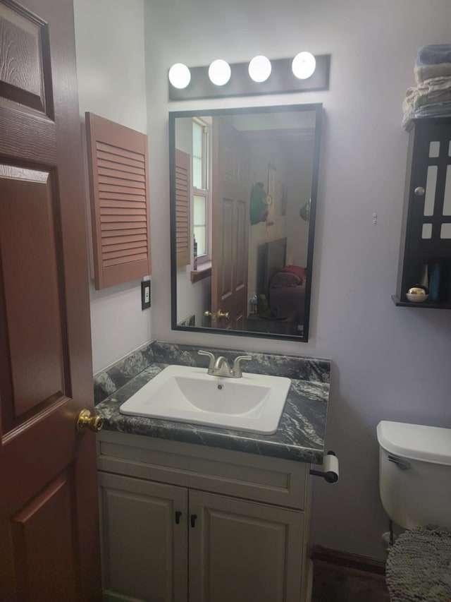 bathroom featuring toilet and vanity