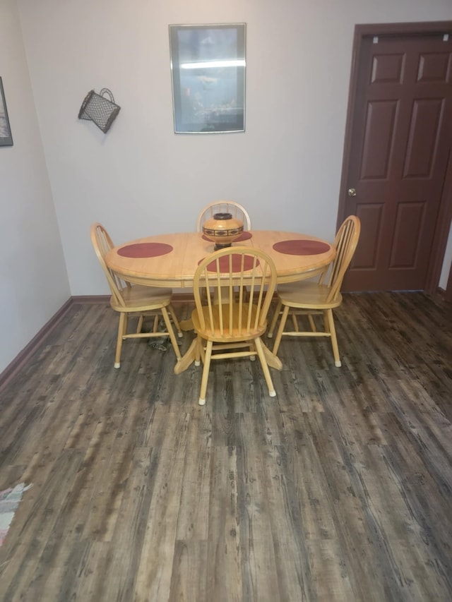 dining area with dark wood-type flooring