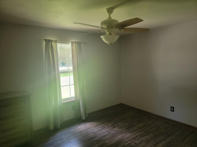 spare room featuring ceiling fan and dark hardwood / wood-style floors