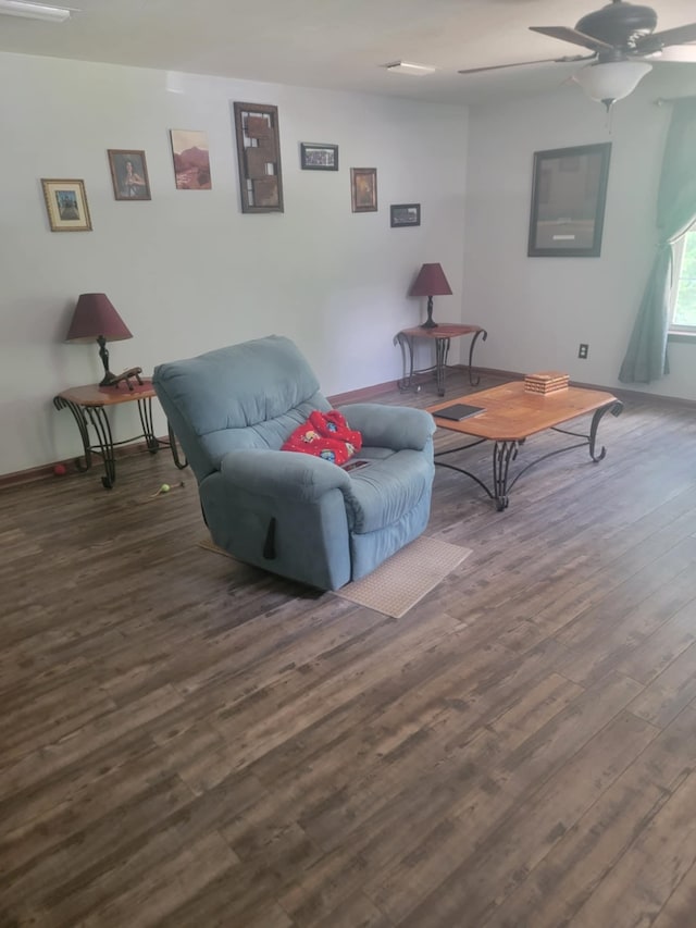 living room featuring dark hardwood / wood-style flooring and ceiling fan