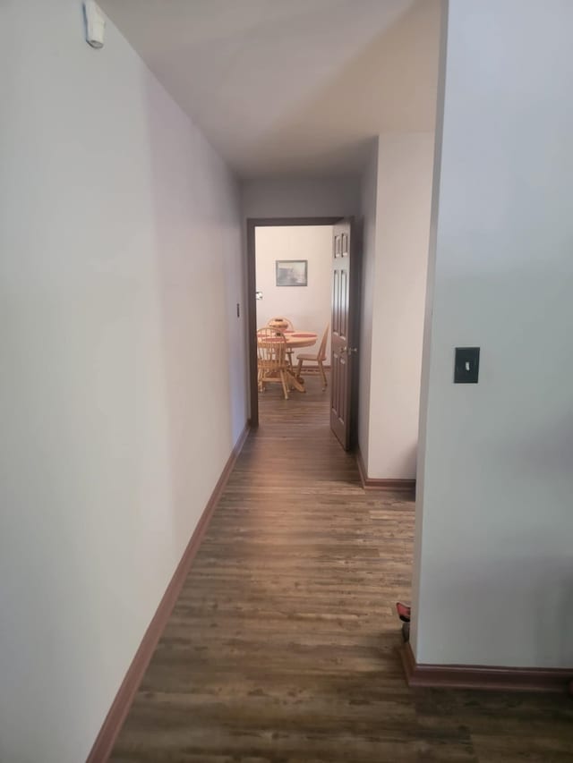 hallway with dark hardwood / wood-style floors