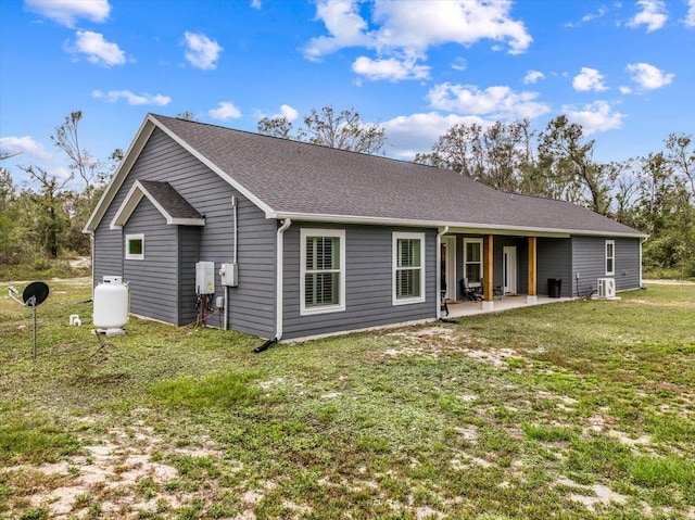 back of house featuring a yard and a patio