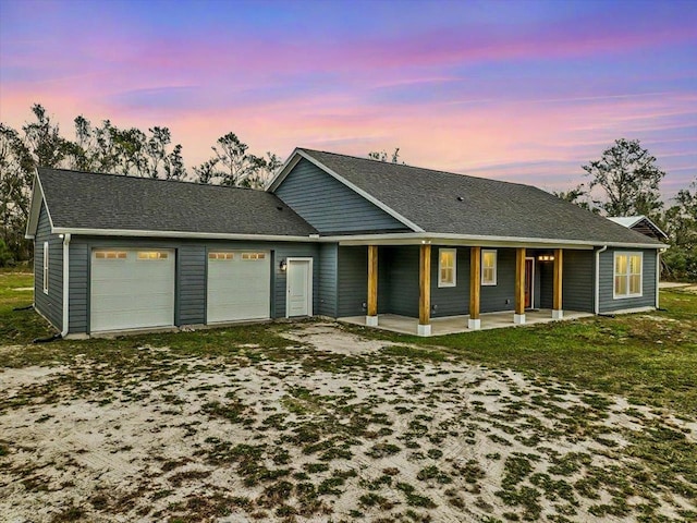 ranch-style house with covered porch and a garage