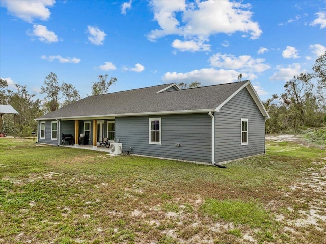 back of house with a yard, a patio, and ac unit