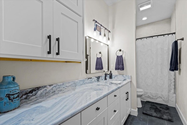 bathroom featuring tile patterned flooring, vanity, toilet, and walk in shower