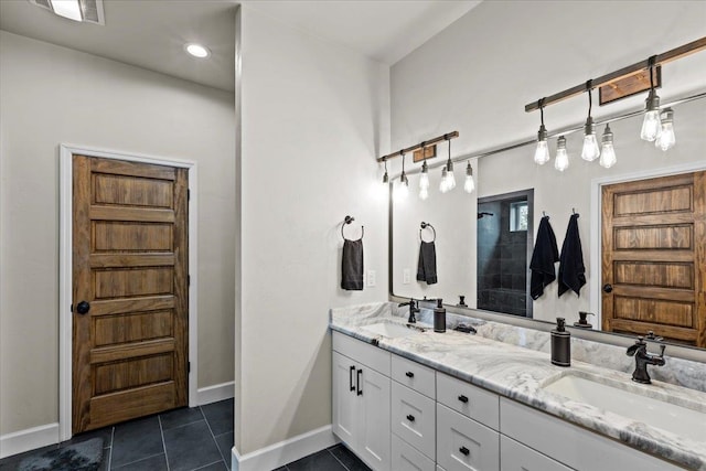 bathroom featuring tile patterned flooring and vanity