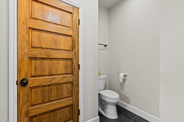 bathroom featuring tile patterned floors and toilet