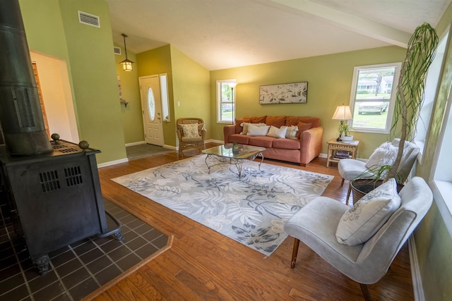 6611 Crooked Creek Rd, Tallahassee, FL 32311 - living room featuring a wood stove, healthy amount of natural light, vaulted ceiling, and wood finished floors