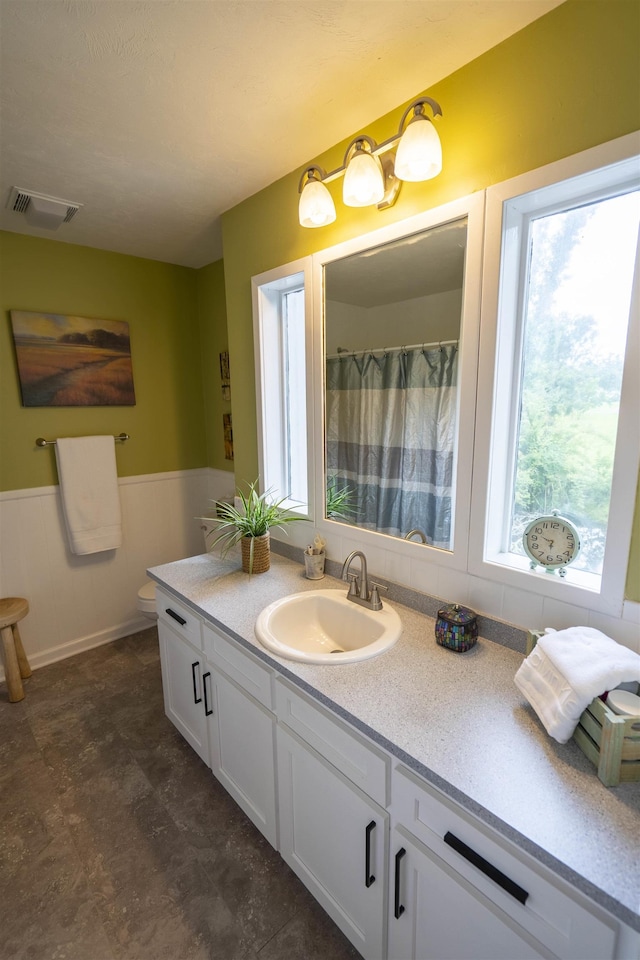 6611 Crooked Creek Rd, Tallahassee, FL 32311 - full bath with healthy amount of natural light, vanity, and a wainscoted wall